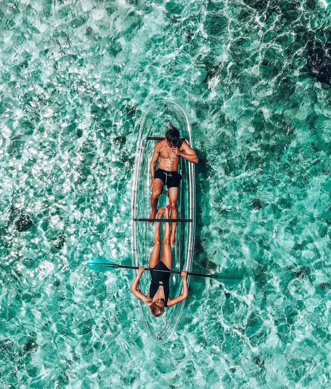 Aerial view of transparent kayaks in tropical water